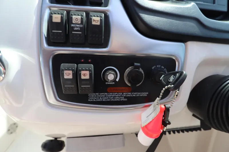Slide: The Image of Control panel of a 2016 Chaparral 287 SSX boat with switches and ignition key. - 38