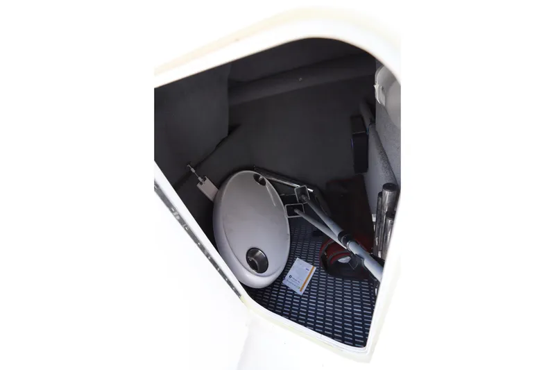 Slide: The Image of Storage compartment in a 2016 Chaparral 287 SSX boat, containing various equipment. - 40