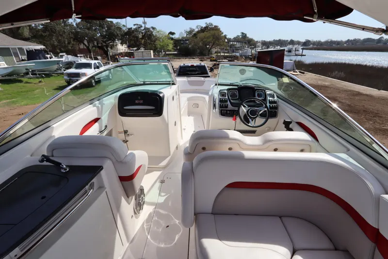 Slide: The Image of Interior view of a 2016 Chaparral 287 SSX boat with luxurious seating and modern dashboard. - 41