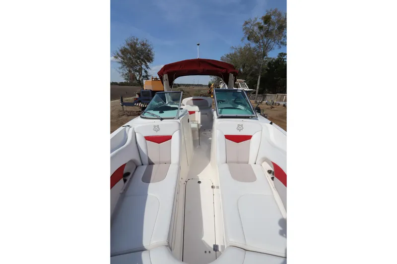 Slide: The Image of 2016 Chaparral 287 SSX boat interior with white and red seating, outdoor setting. - 47