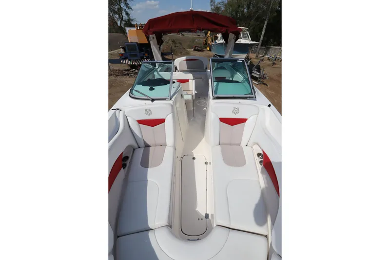 Slide: The Image of 2016 Chaparral 287 SSX boat interior with white and red seating, open deck view. - 48