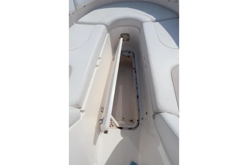 Slide: The Image of 2016 Chaparral 287 SSX boat interior storage compartment open, showcasing seating area. - 49