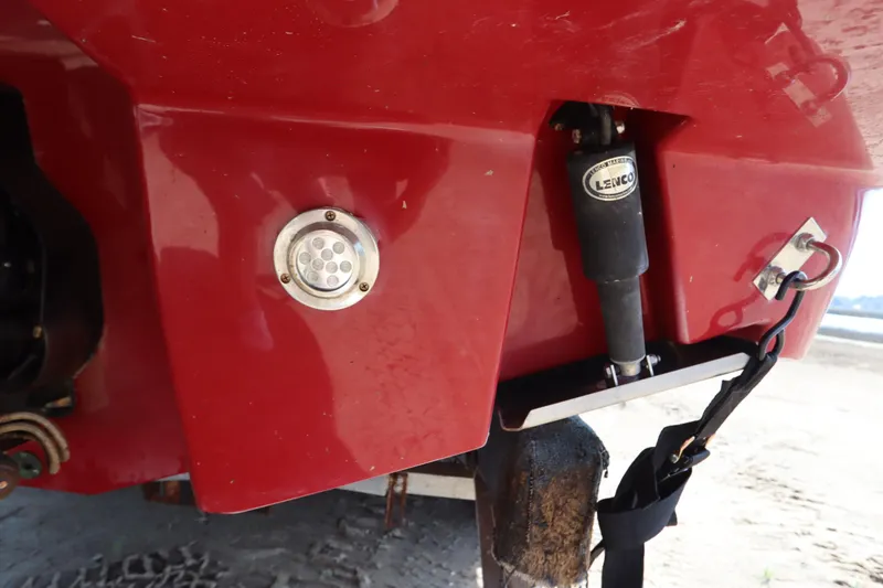 Slide: The Image of Close-up of 2016 Chaparral 287 SSX boat's red hull with Lenco trim tab. - 5