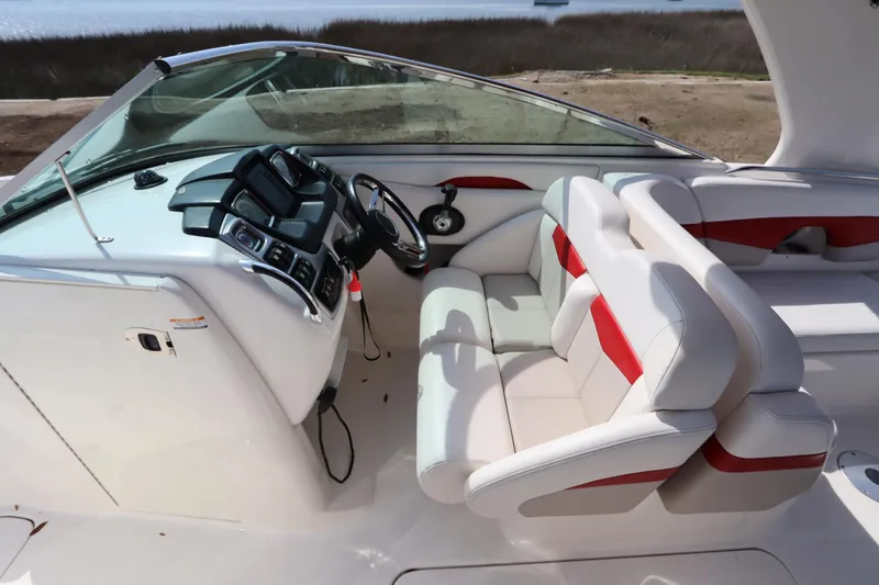 Slide: The Image of 2016 Chaparral 287 SSX boat interior with white and red seating, sleek dashboard. - 51