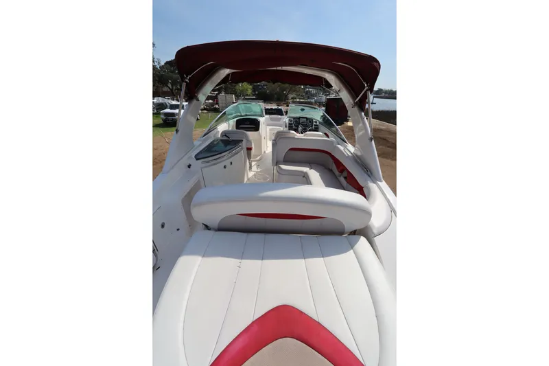 Slide: The Image of 2016 Chaparral 287 SSX boat interior with white and red seating, open canopy. - 52