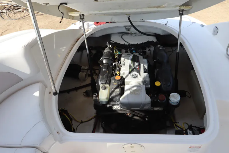 Slide: The Image of Engine compartment of a 2016 Chaparral 287 SSX boat, showcasing the V8 engine. - 54