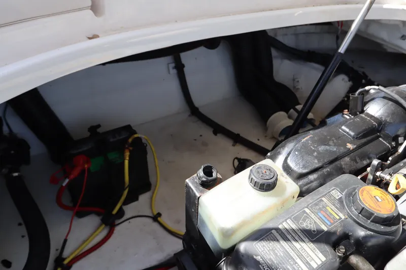 Slide: The Image of Engine compartment of a 2016 Chaparral 287 SSX boat, showing battery and engine components. - 56