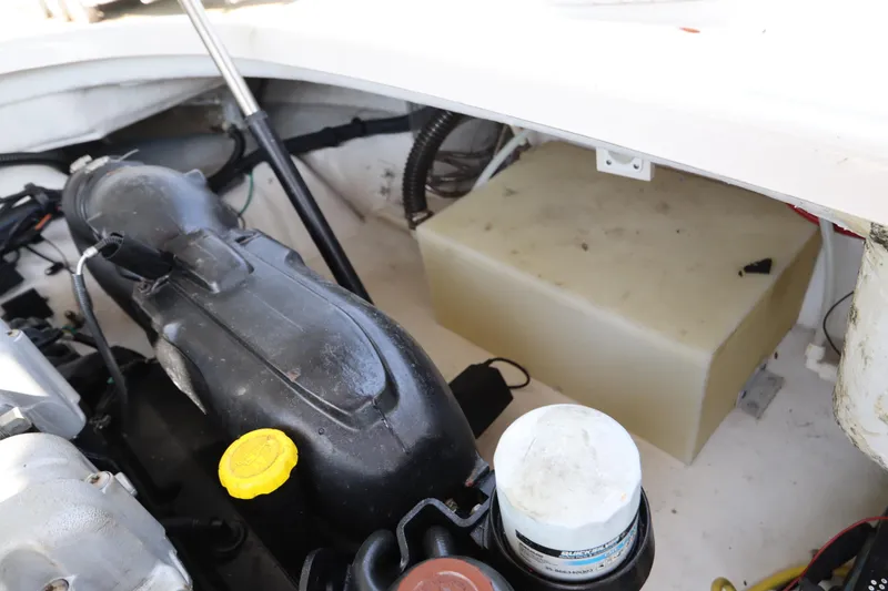 Slide: The Image of Engine compartment of a 2016 Chaparral 287 SSX boat, showing components and storage area. - 57