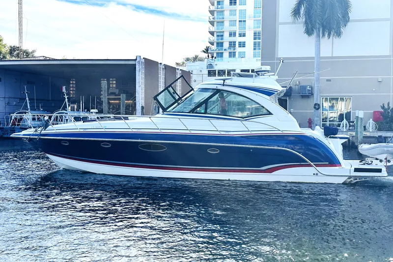 The Image of 2012 Formula 45 Yacht docked near a marina, with modern buildings in the background. - 0
