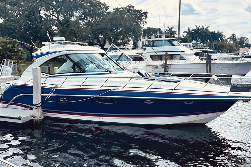 Slide: The Image of 2012 Formula 45 Yacht docked at marina, featuring sleek blue and white design. - 1