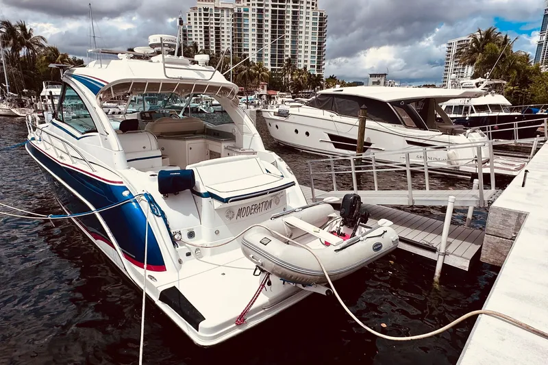 Slide: The Image of 2012 Formula 45 Yacht docked with inflatable boat, surrounded by other yachts. - 2