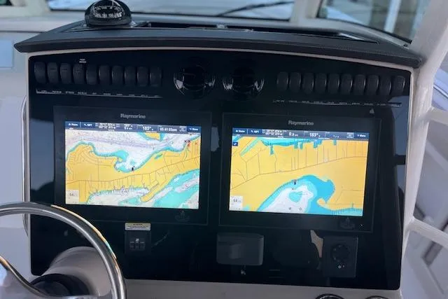 Slide: The Image of Dashboard of 2018 Boston Whaler 380 Outrage with dual Raymarine navigation screens. - 11