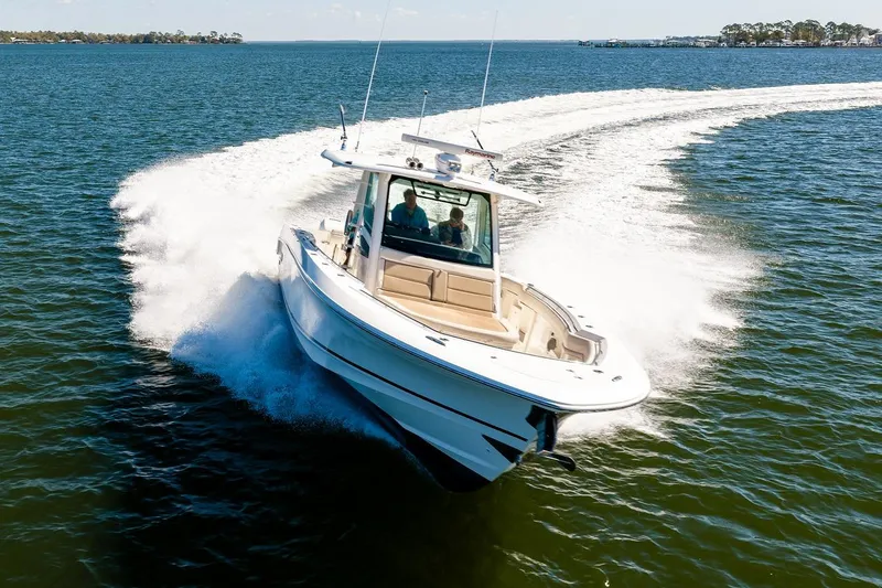 Slide: The Image of 2018 Boston Whaler 380 Outrage speeding on open water, creating a dynamic wake. - 13
