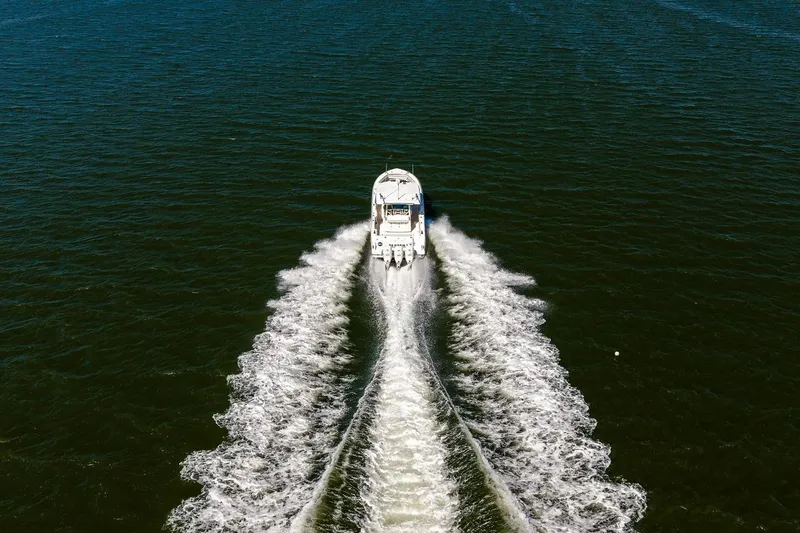 Slide: The Image of 2018 Boston Whaler 380 Outrage cruising on open water, aerial view. - 17