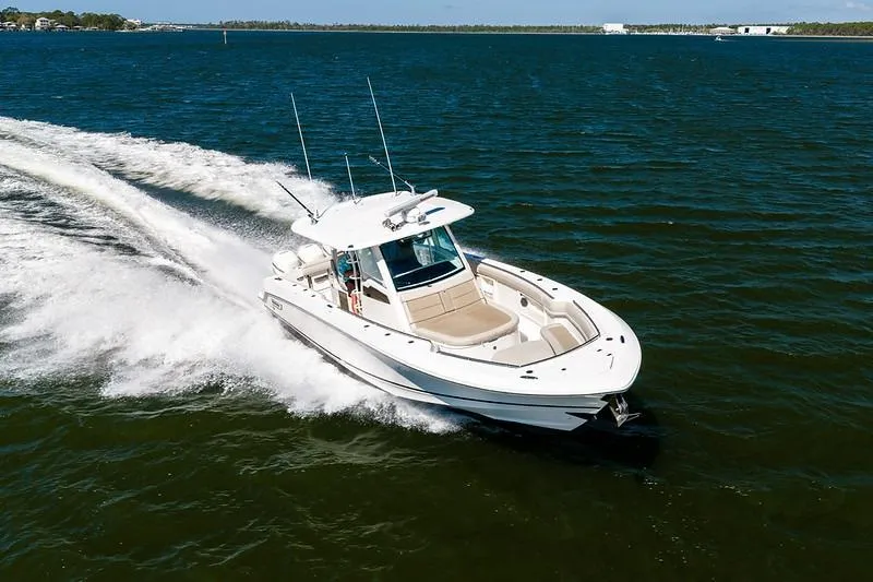 Slide: The Image of 2018 Boston Whaler 380 Outrage cruising on open water, showcasing sleek design and performance. - 19