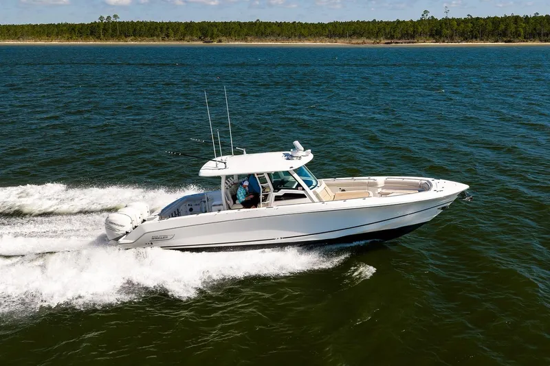 Slide: The Image of 2018 Boston Whaler 380 Outrage cruising on open water, showcasing sleek design and performance. - 20