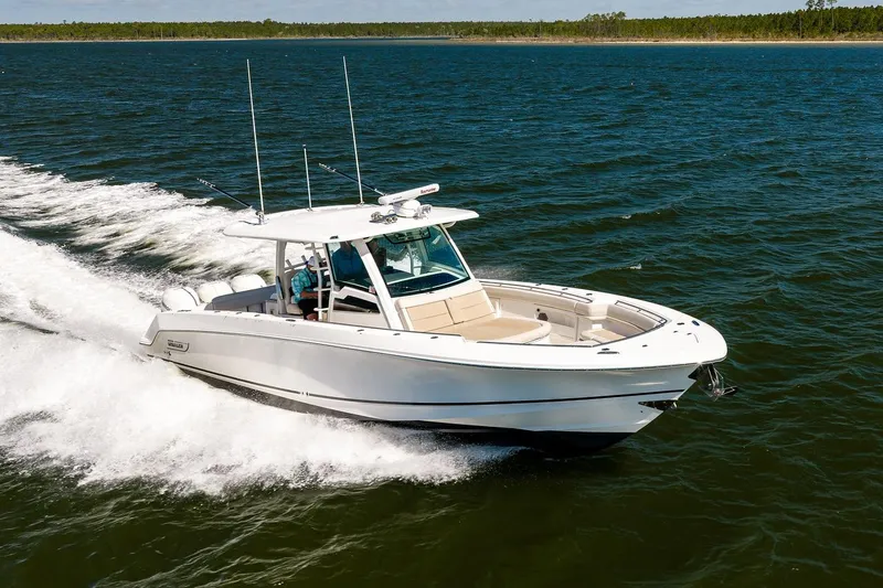 Slide: The Image of 2018 Boston Whaler 380 Outrage cruising on open water, showcasing sleek design and performance. - 21