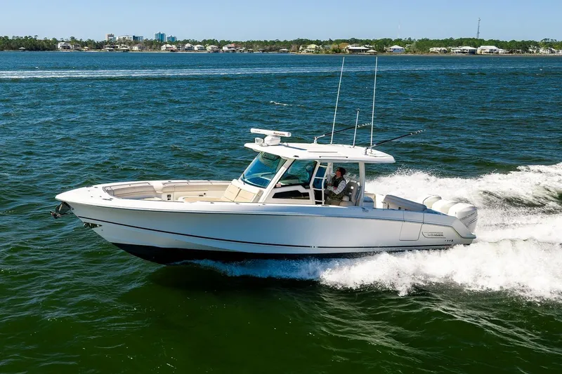 Slide: The Image of 2018 Boston Whaler 380 Outrage cruising on open water, showcasing sleek design and performance. - 22
