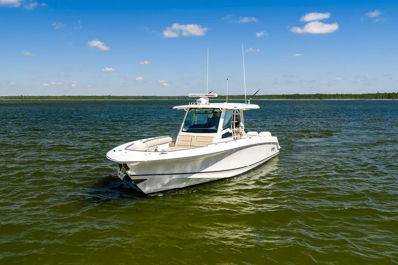 Slide: The Image of 2018 Boston Whaler 380 Outrage boat on calm water under clear blue sky. - 25