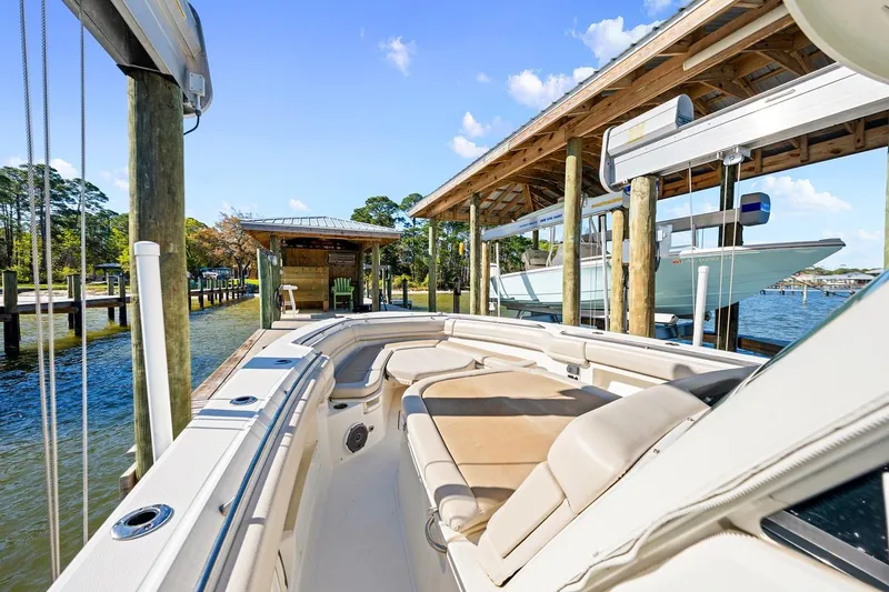 Slide: The Image of 2018 Boston Whaler 380 Outrage docked at a scenic marina under clear blue skies. - 30