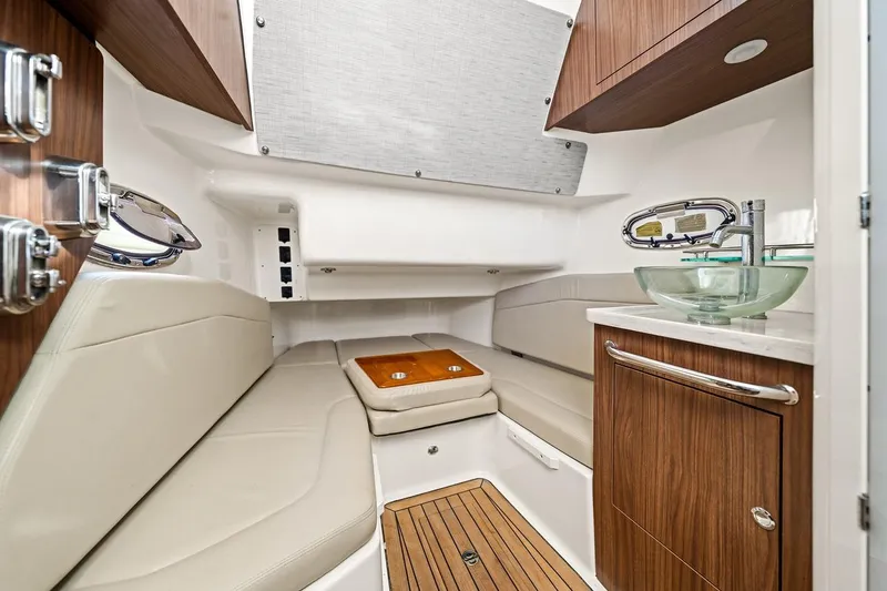 Slide: The Image of Interior cabin of 2018 Boston Whaler 380 Outrage with modern amenities and wood accents. - 32