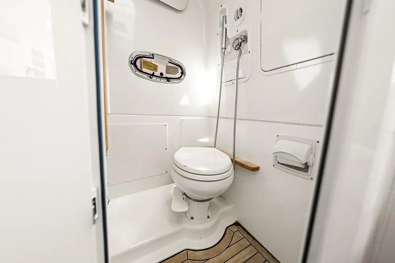 Slide: The Image of 2018 Boston Whaler 380 Outrage boat bathroom with toilet and shower. - 34