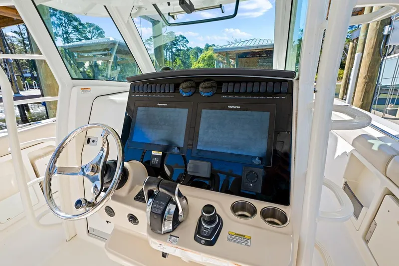 Slide: The Image of 2018 Boston Whaler 380 Outrage helm with dual Raymarine displays and steering wheel. - 37