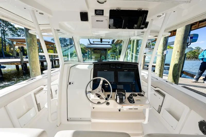 Slide: The Image of 2018 Boston Whaler 380 Outrage helm with modern controls and dual displays. - 38