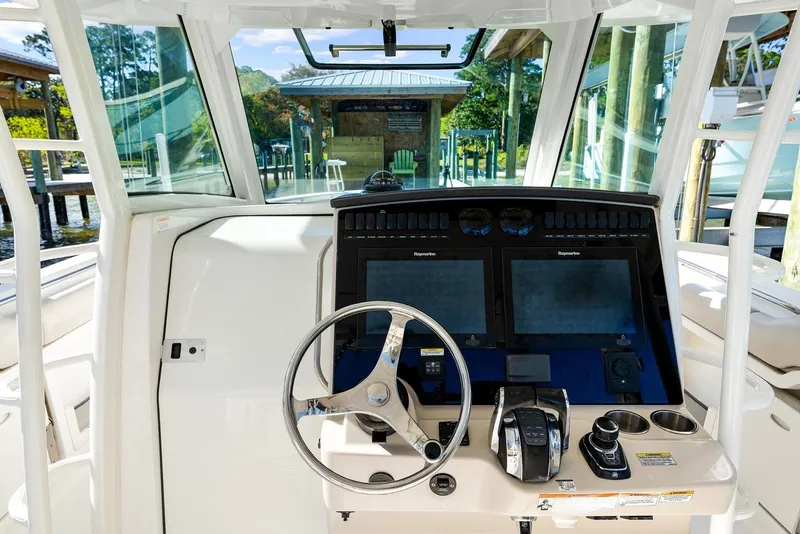 Slide: The Image of 2018 Boston Whaler 380 Outrage helm with dual Raymarine displays and steering wheel. - 39