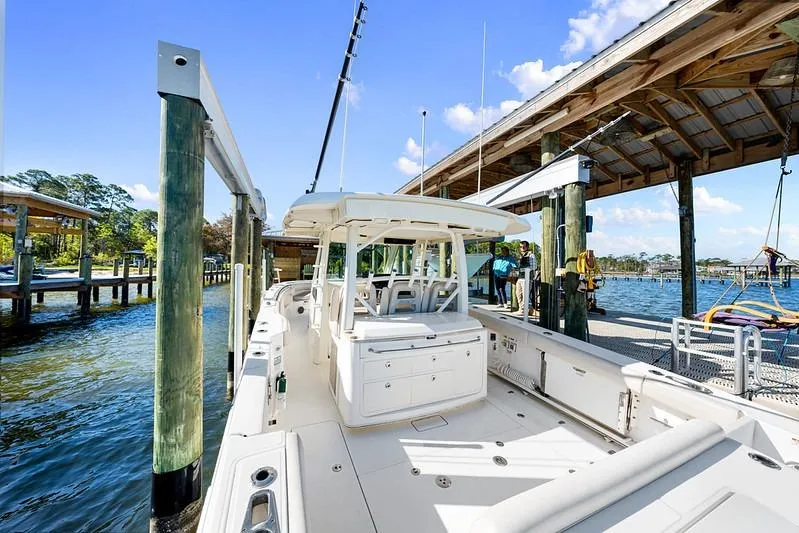 Slide: The Image of 2018 Boston Whaler 380 Outrage docked at a marina under clear blue skies. - 41
