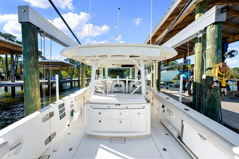 Slide: The Image of 2018 Boston Whaler 380 Outrage docked, showcasing spacious deck and seating area. - 42