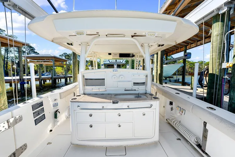 Slide: The Image of 2018 Boston Whaler 380 Outrage boat interior with fishing station and storage compartments. - 45