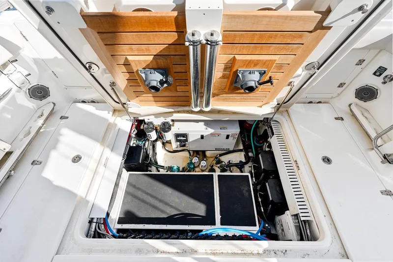 Slide: The Image of Engine compartment of 2018 Boston Whaler 380 Outrage, showcasing Kohler generator and mechanical components. - 46