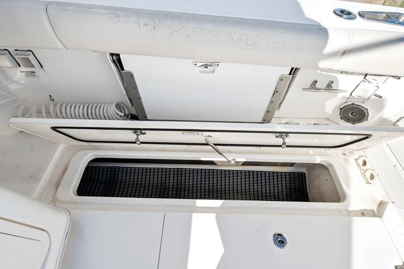 Slide: The Image of 2018 Boston Whaler 380 Outrage boat storage compartment with open hatch. - 49
