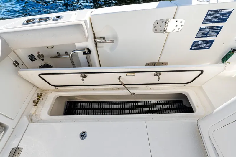 Slide: The Image of 2018 Boston Whaler 380 Outrage boat deck with storage compartment and utility sink. - 50
