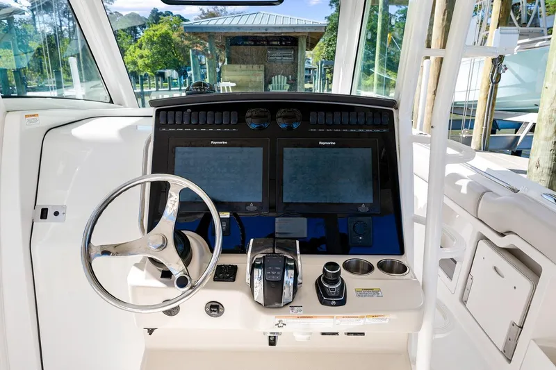Slide: The Image of 2018 Boston Whaler 380 Outrage helm with dual Raymarine displays and stainless steel steering wheel. - 51