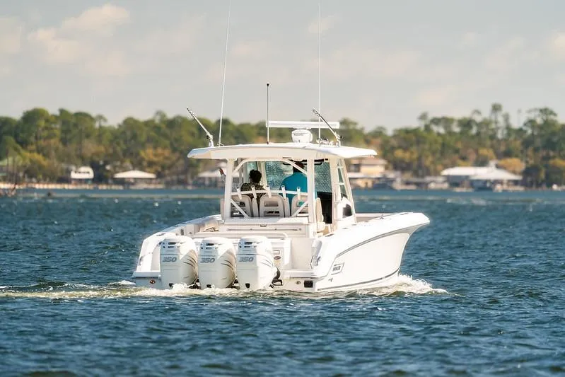 Slide: The Image of 2018 Boston Whaler 380 Outrage cruising on a scenic lake. - 59