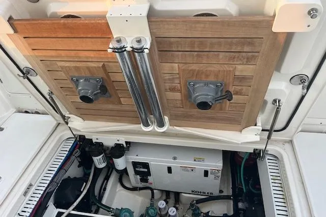 Slide: The Image of Engine compartment of 2018 Boston Whaler 380 Outrage with Kohler generator and wooden paneling. - 6