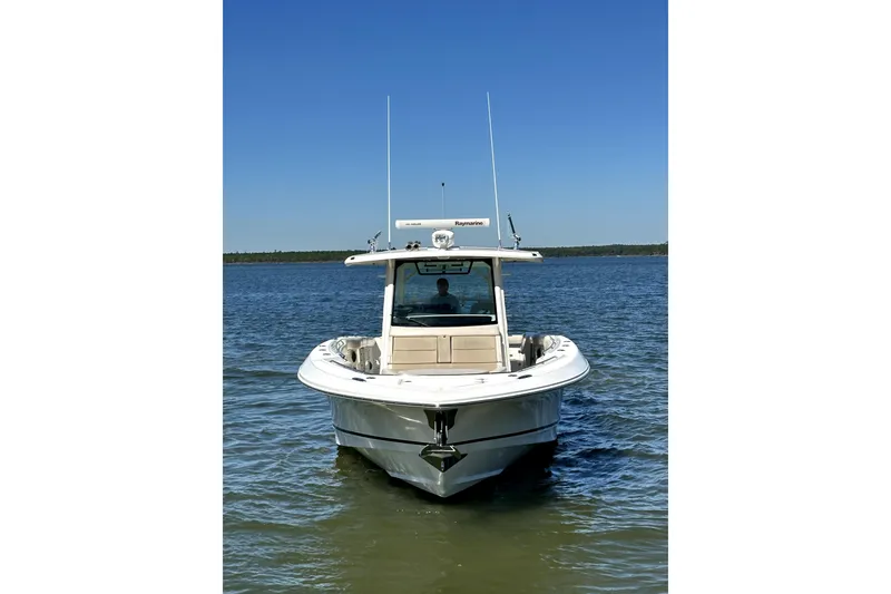 Slide: The Image of 2018 Boston Whaler 380 Outrage boat on calm water under clear blue sky. - 9