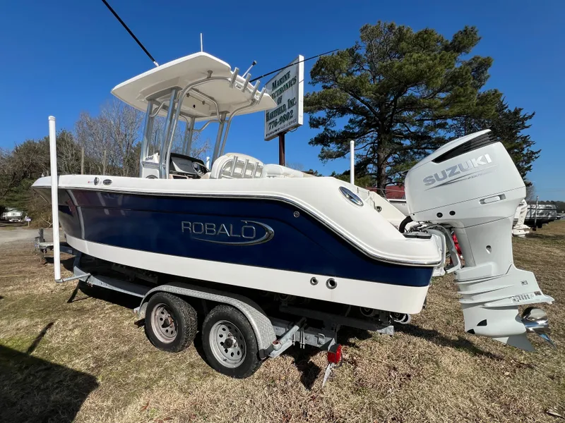 Slide: The Image of 2020 Robalo R242 Center Console boat with Suzuki engine. - 2