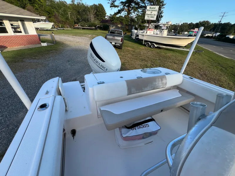 Slide: The Image of The image shows the stern of a 2020 Robalo R242 Center Console boat with an outboard motor. - 28