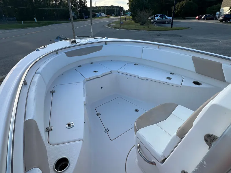Slide: The Image of The image shows the bow of a 2020 Robalo R242 Center Console boat with seating and storage. - 21