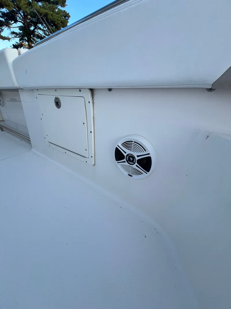 Slide: The Image of Close-up of a white boat deck with a speaker and storage compartment. - 38