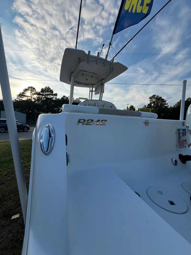 Slide: The Image of Robalo R242 Center Console 2020 with spacious deck and T-top, ideal for fishing trips. - 30