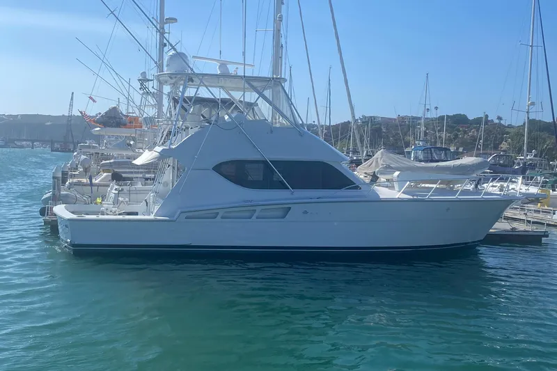 Slide: The Image of 2001 Hatteras 50 Convertible yacht docked in harbor. - 2