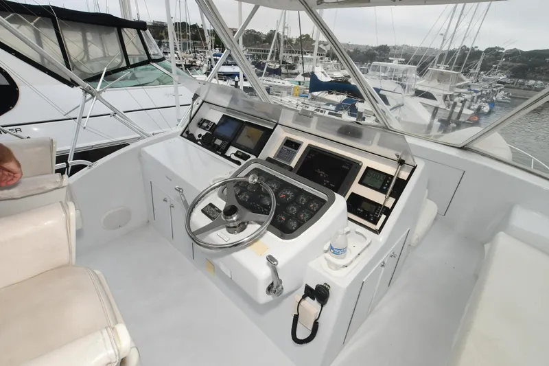 Slide: The Image of Helm of 2001 Hatteras 50 Convertible yacht in marina. - 26