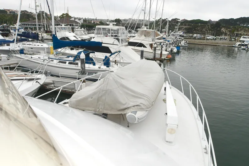 Slide: The Image of 2001 Hatteras 50 Convertible docked among other boats. - 33