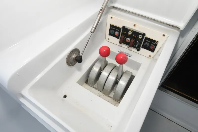 Slide: The Image of Control console of 2001 Hatteras 50 Convertible with levers and switches. - 36