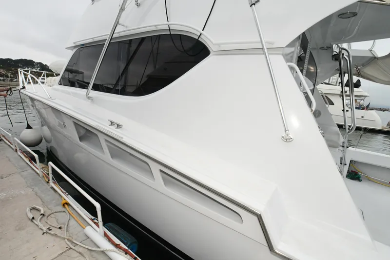 Slide: The Image of 2001 Hatteras 50 Convertible yacht docked, side view. - 38