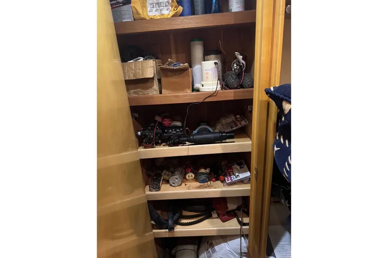 Slide: The Image of Storage shelves with various tools and supplies on a 2001 Hatteras 50 Convertible boat. - 40